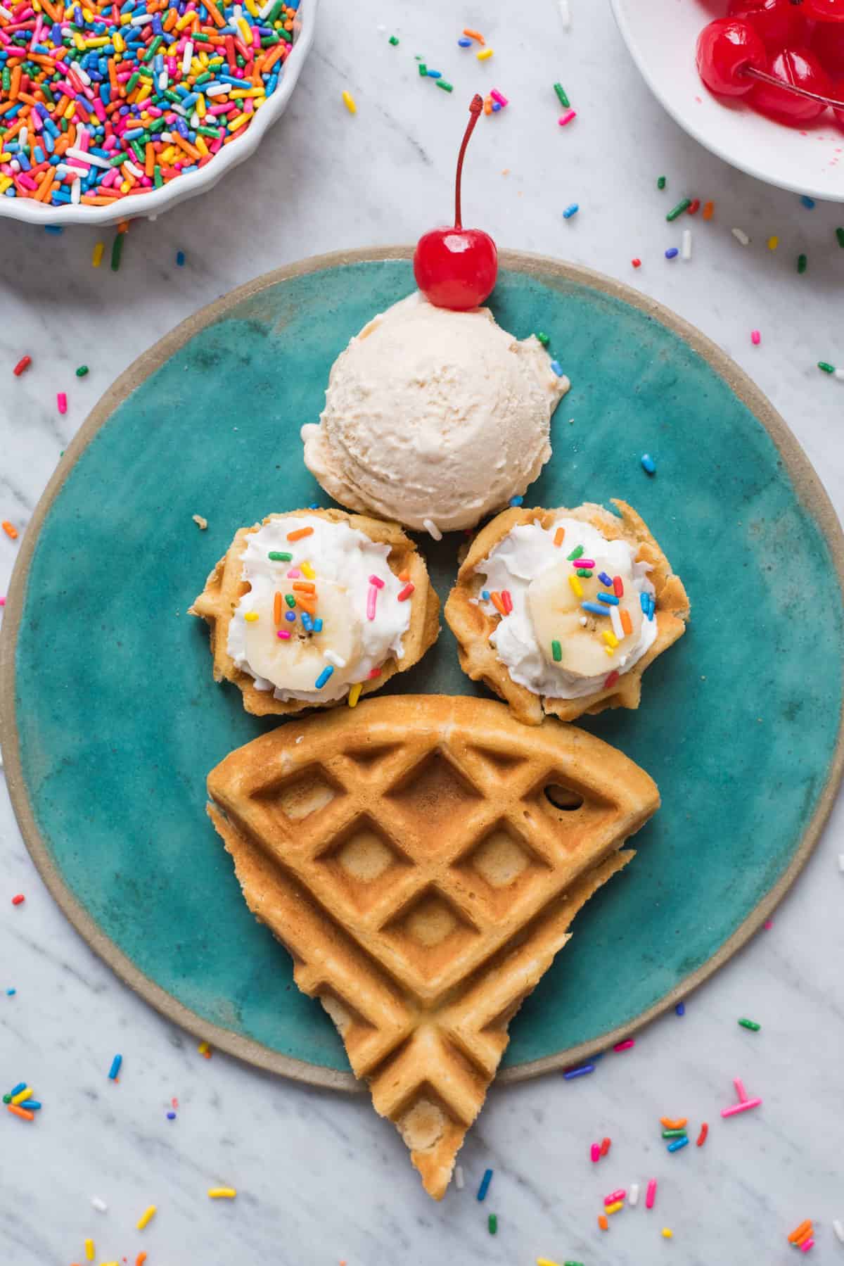 waffles cut and arranged in the shape of an ice cream cone on teal plate on white background