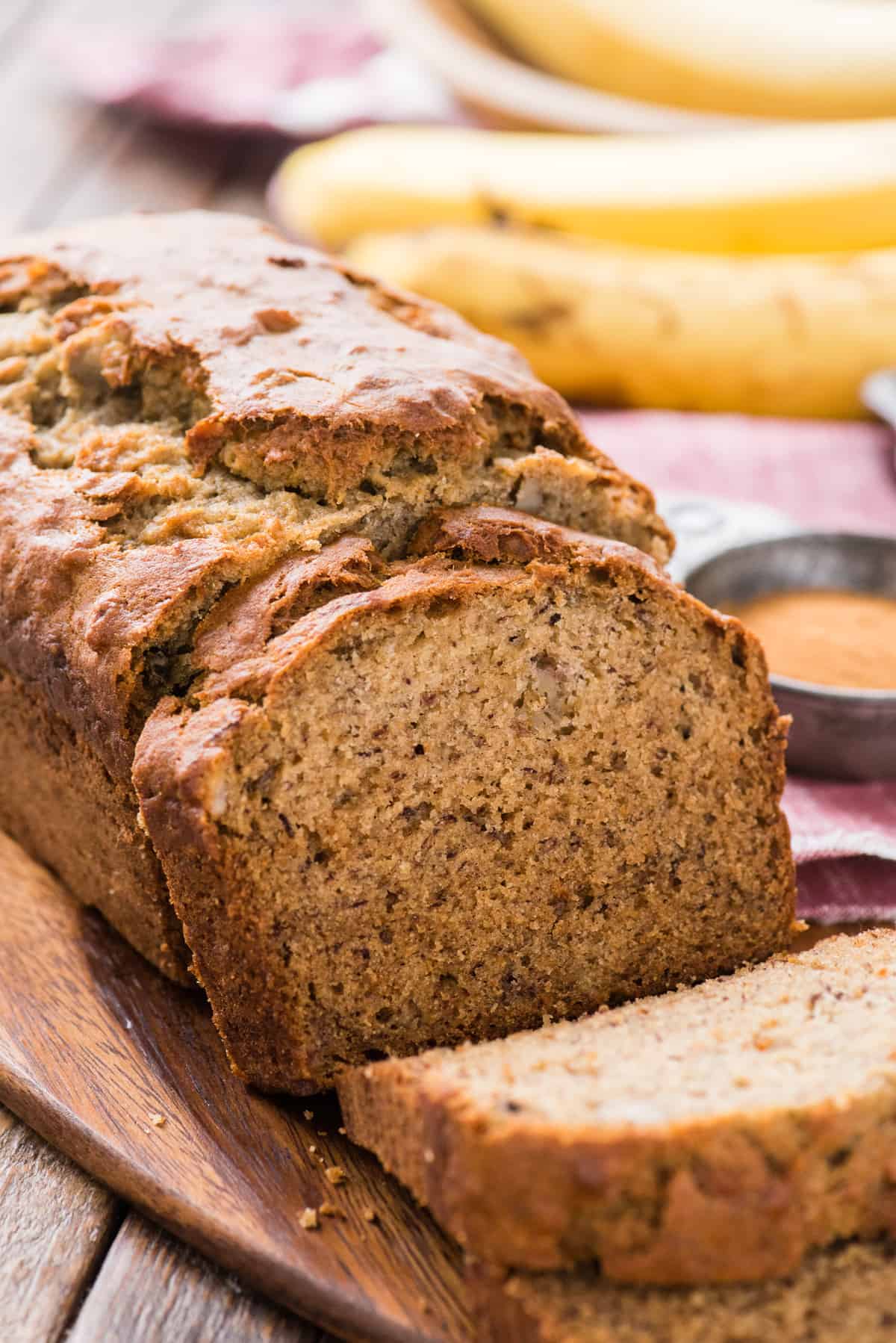 sliced banana bread displayed on wooden cutting board