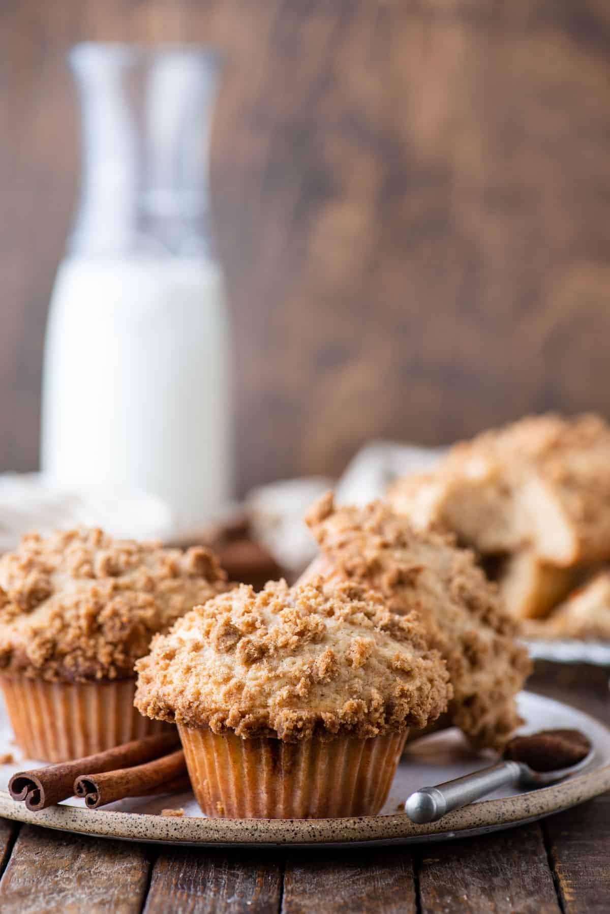 coffee cake muffins on a white plate on a wood background