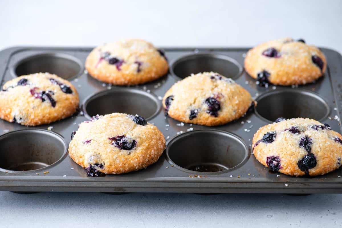 6 baked blueberries muffins in muffin pan