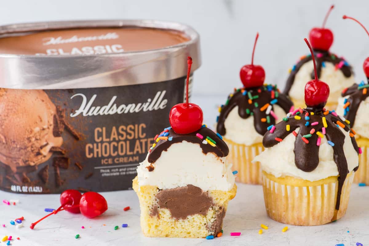 ice cream cupcakes arranged on white surface with Hudsonville ice cream container in the background