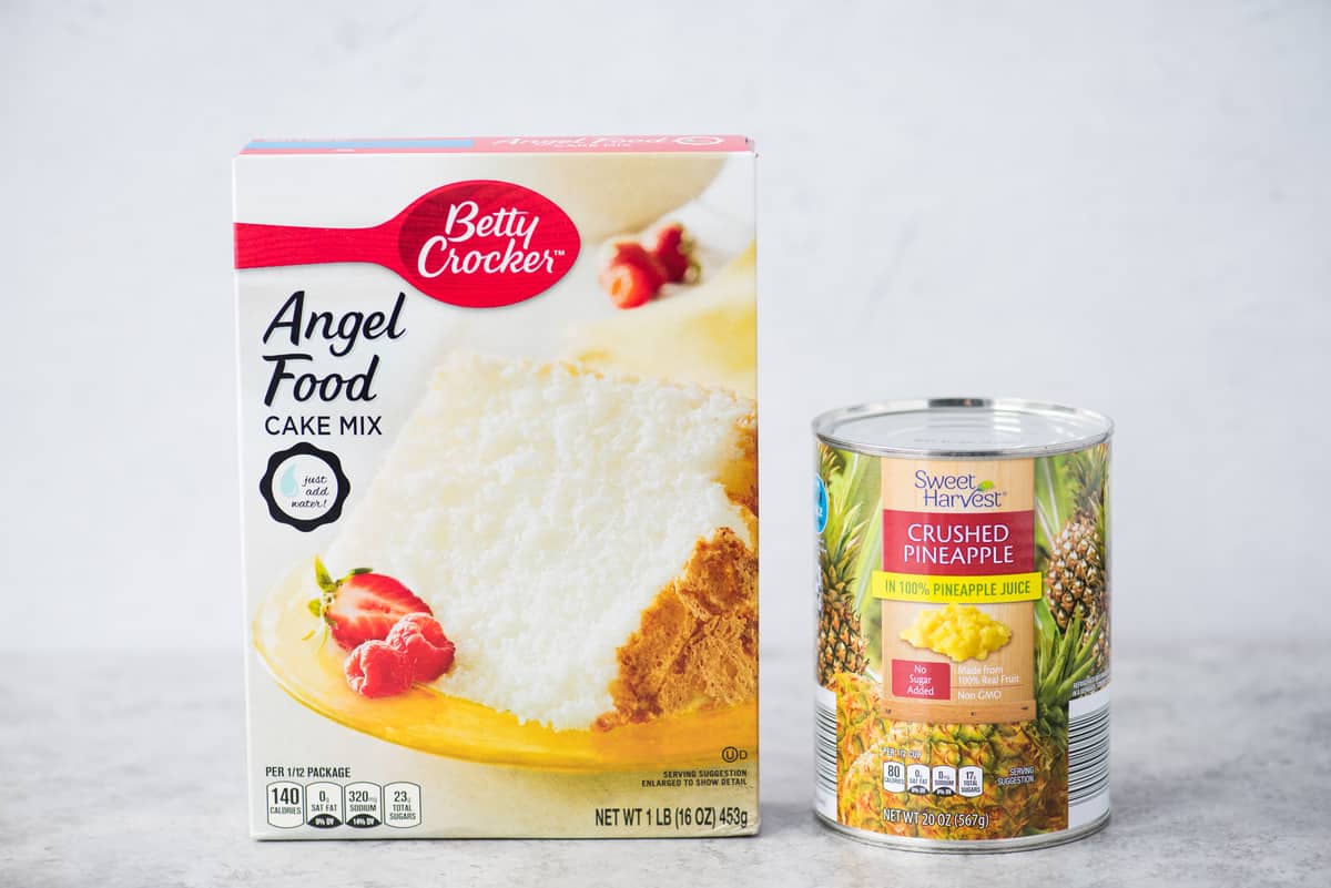 box of angel food cake mix and can of crushed pineapple on white background