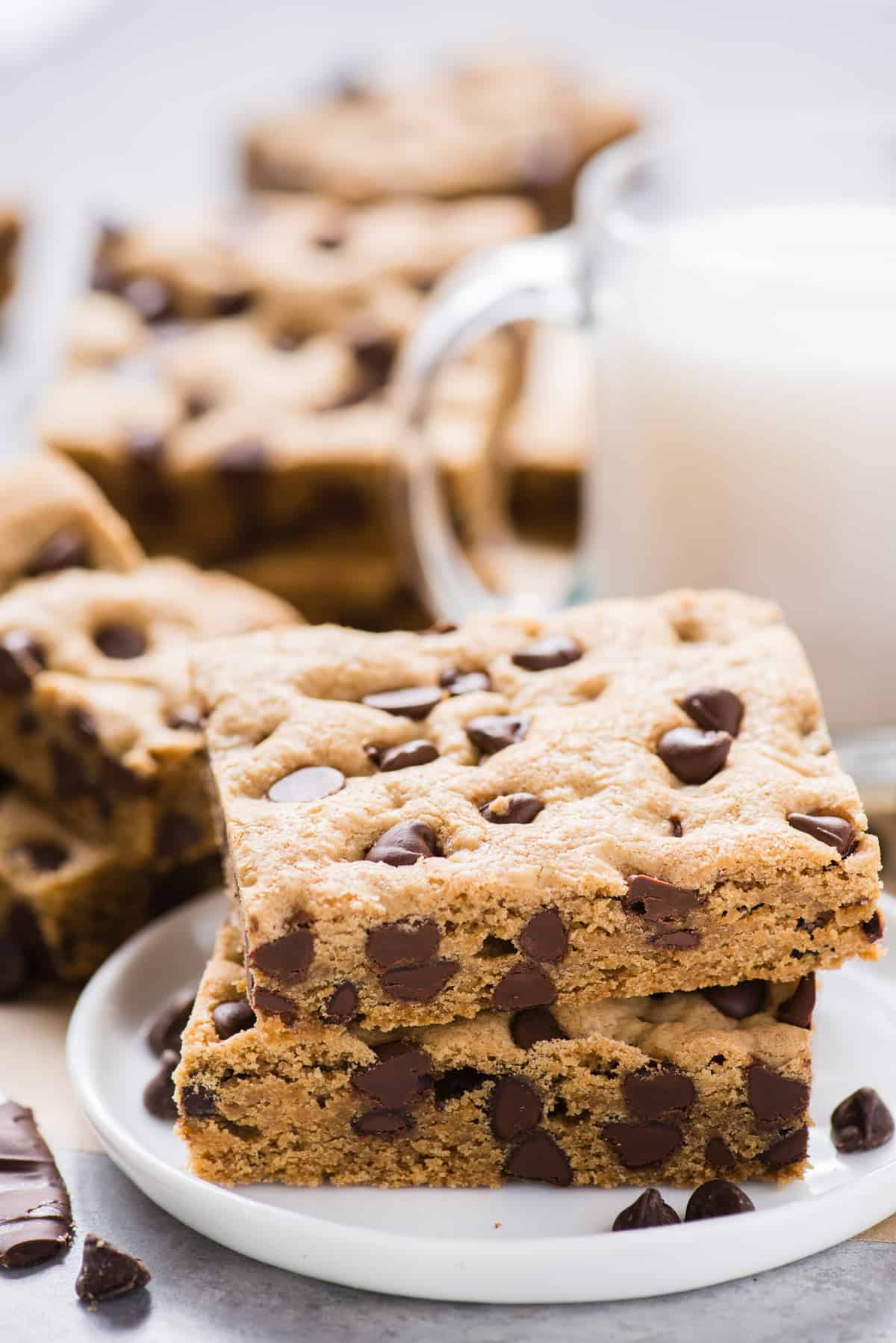 2 chocolate chip cookie bars cut into squares on white plate