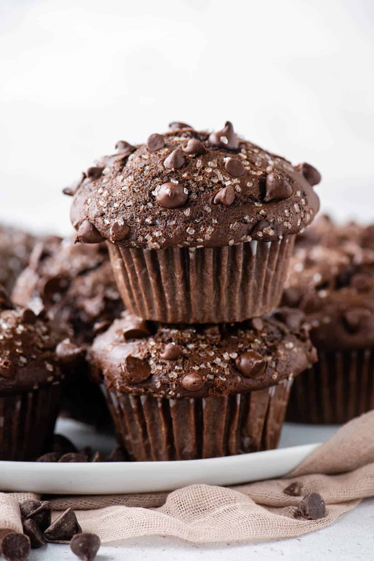 two chocolate muffins stacked on top of each other