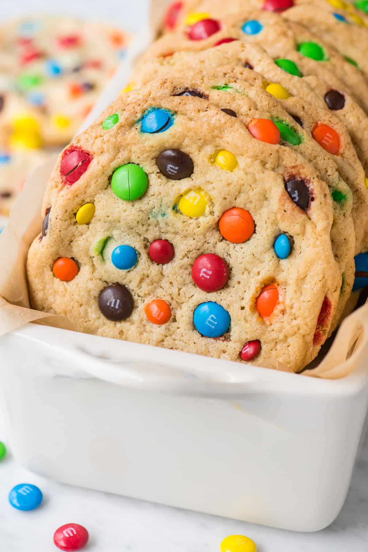 M&M cookies propped up in white loaf pan 