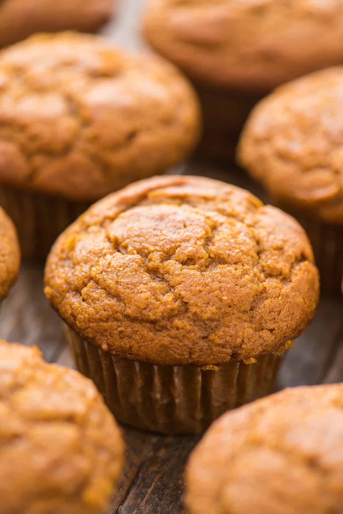 close up of pumpkin muffins on wooden background