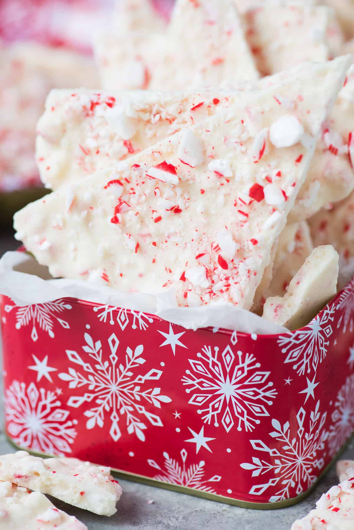 white chocolate peppermint bark in red christmas tin