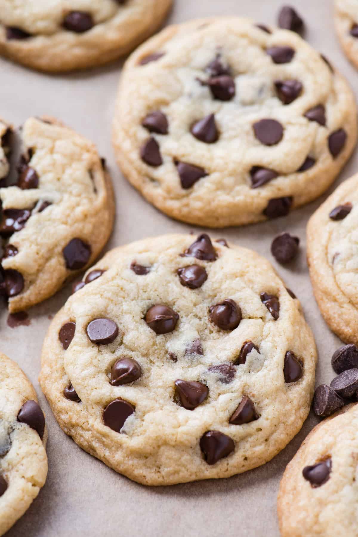 gluten free chocolate chip cookies arranged randomly on brown parchment paper
