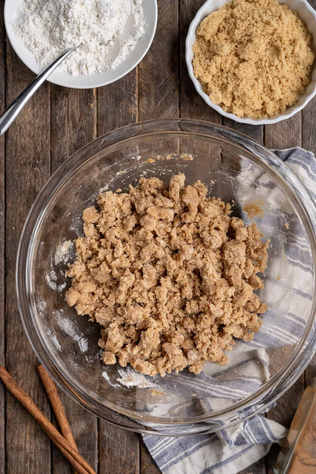 crumb topping in glass bowl on wood background