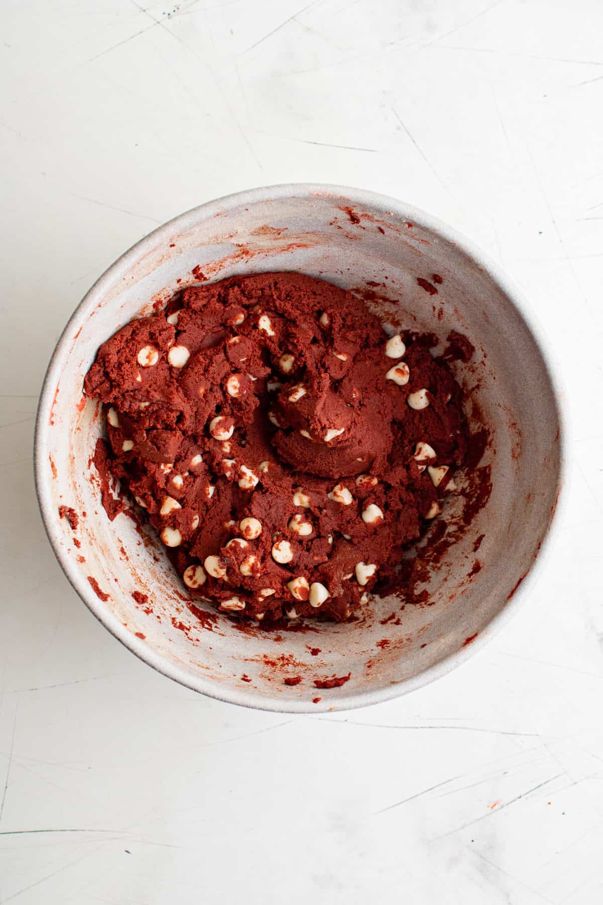 red velvet cookie dough in bowl on white background