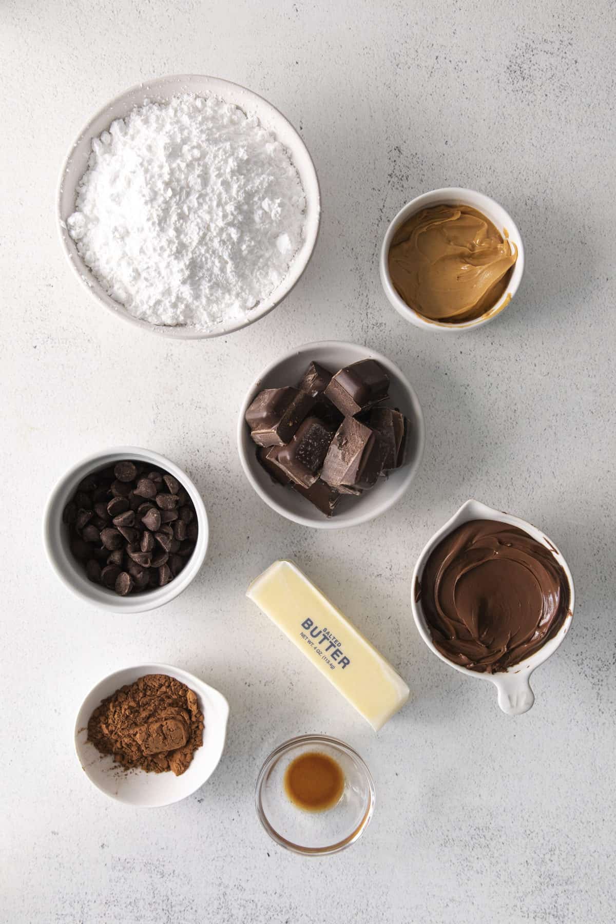 ingredients to make chocolate buckeyes on white background