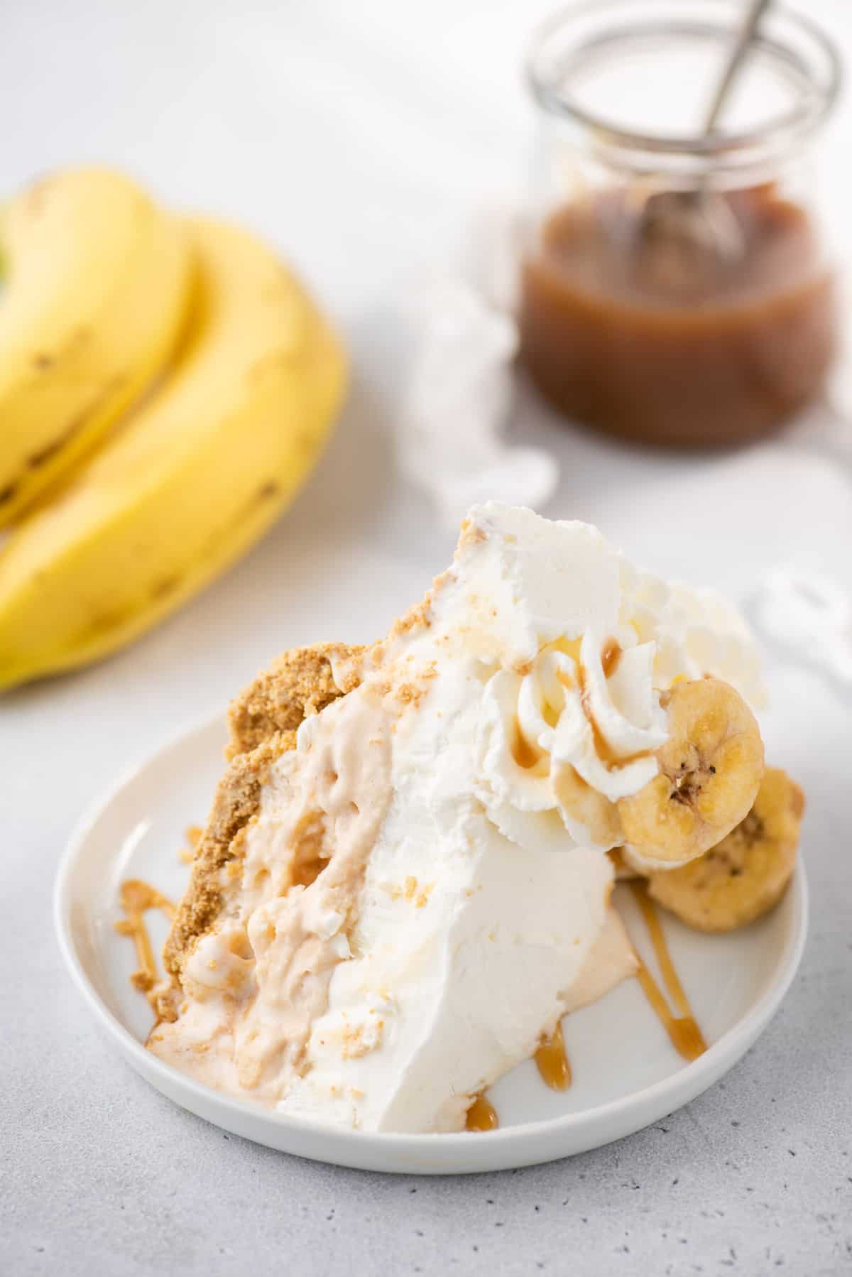 slice of bananas foster ice cream pie on white plate