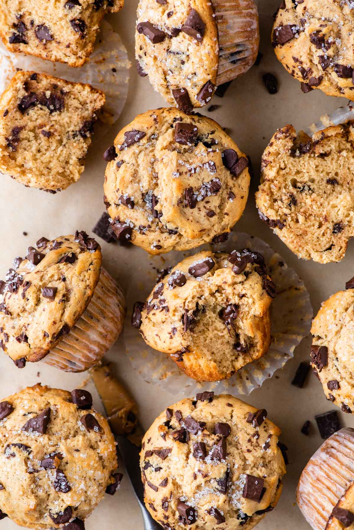 peanut butter muffins with chocolate chips arranged in a grid pattern on brown parchment paper