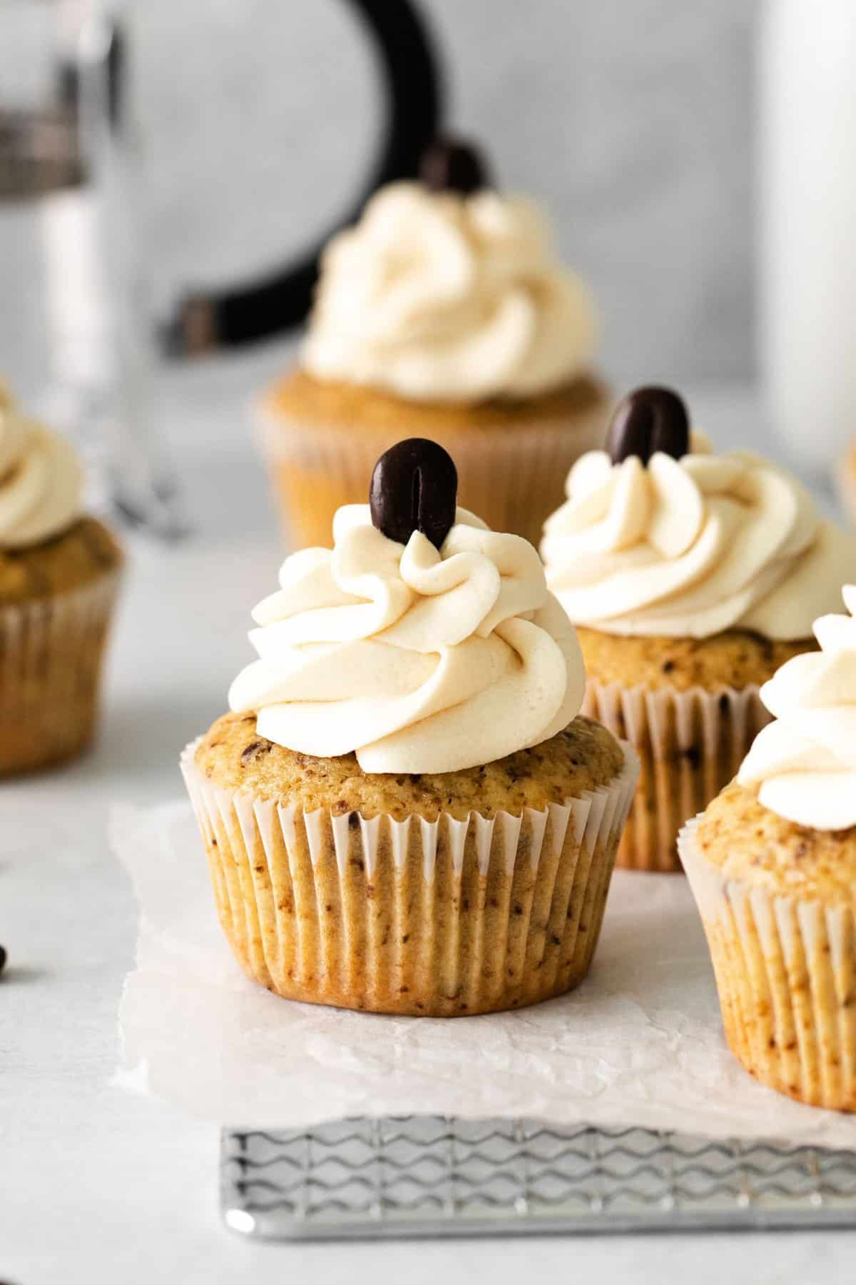 espresso cupcakes topped with coffee frosting and a coffee bean