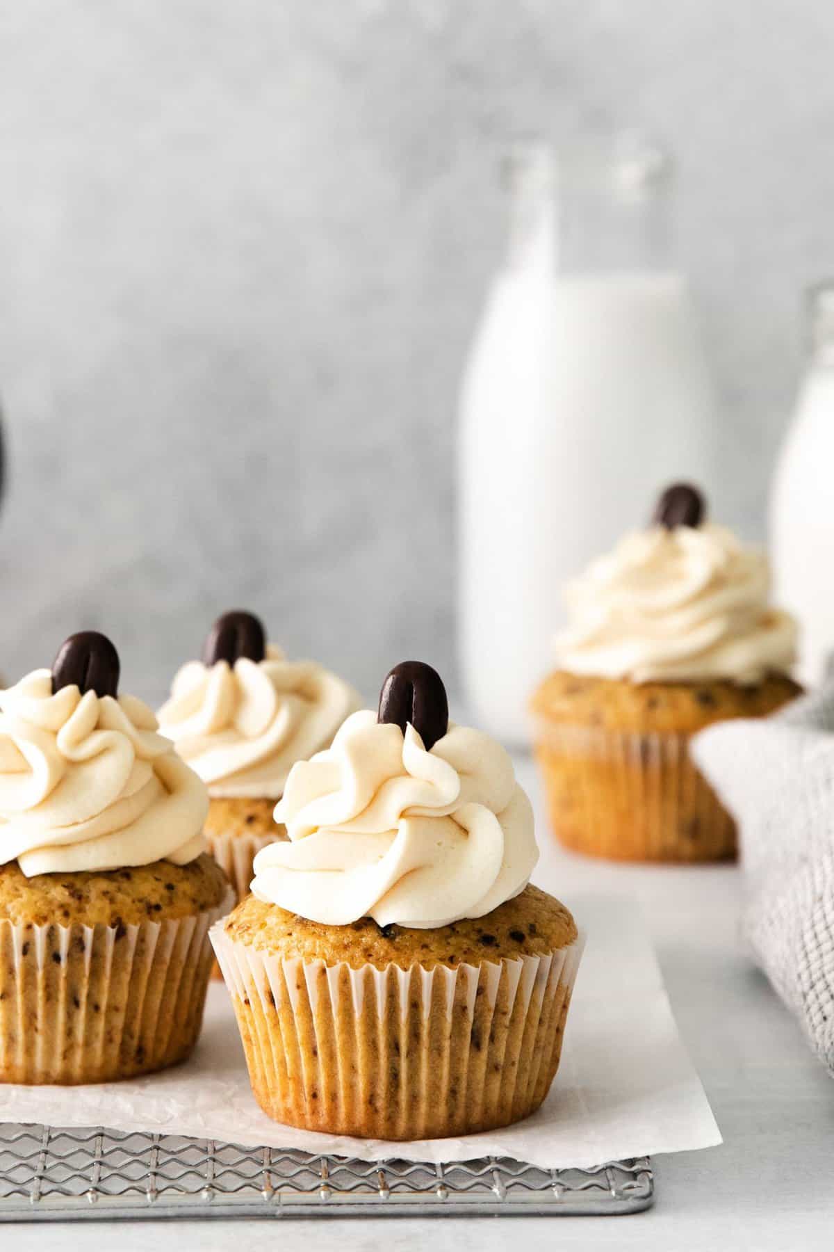 espresso cupcakes topped with coffee frosting and a coffee bean