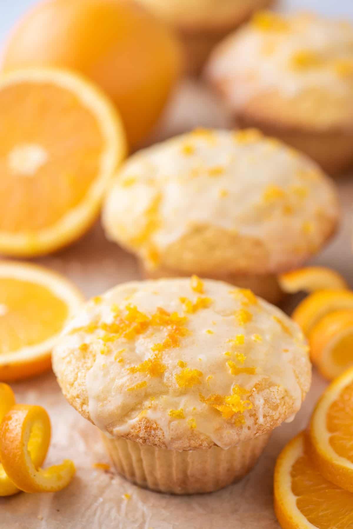 orange muffins with orange slices in the background