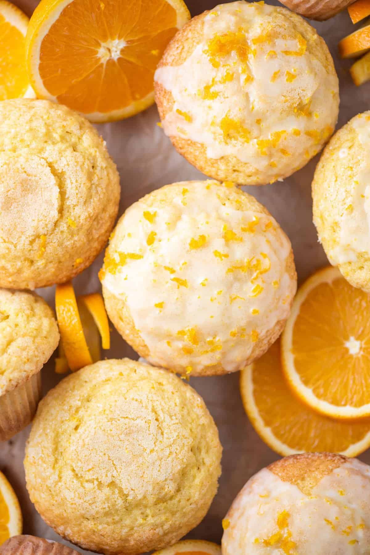 orange muffins arranged in a grid pattern with orange slices
