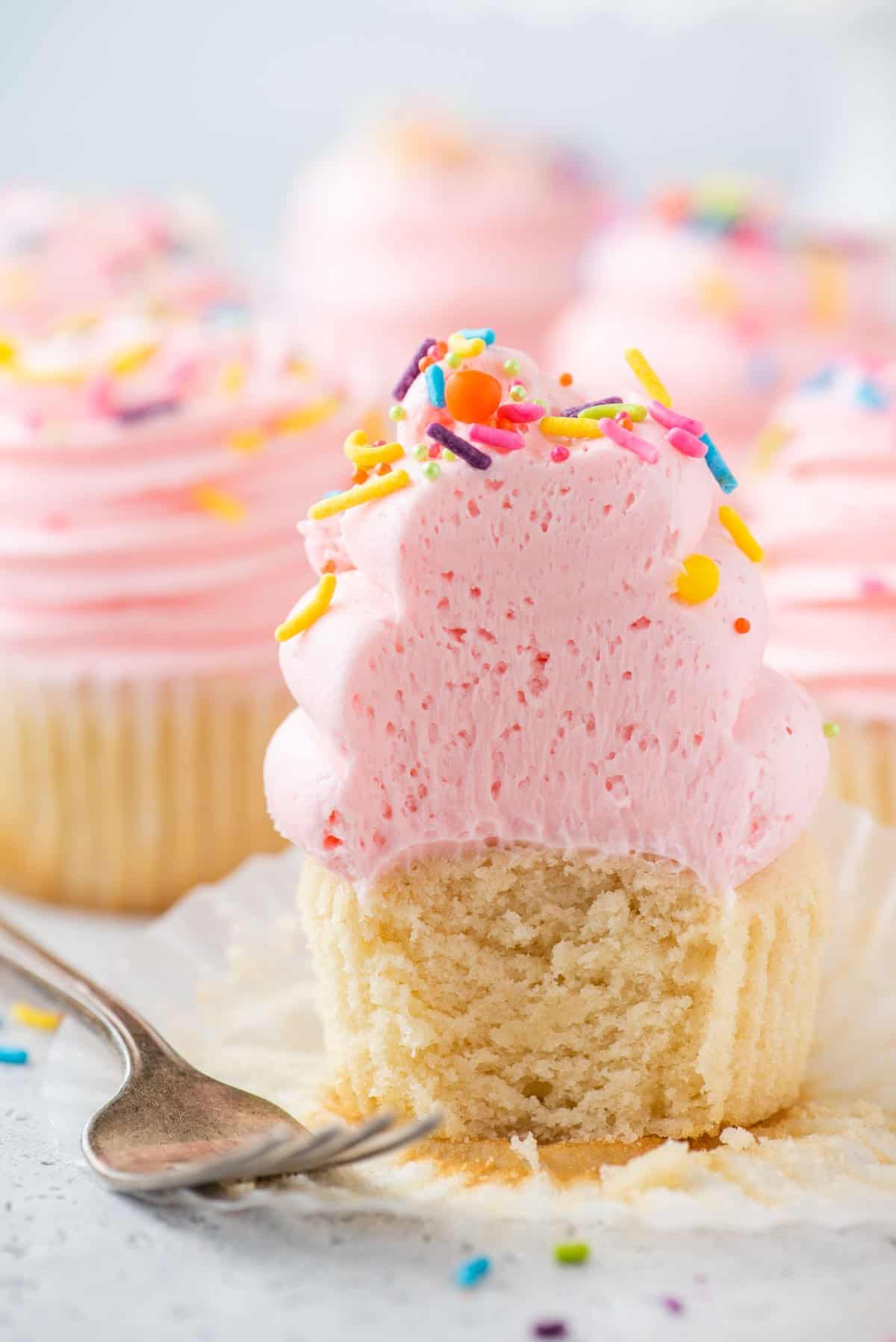 Gluten-free cupcake with bite taken out to show fluffy texture