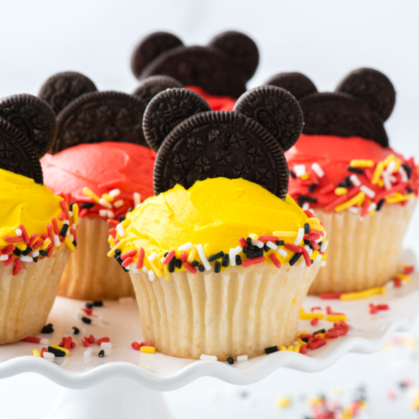 Mickey Mouse cupcakes on cake stand with sprinkles