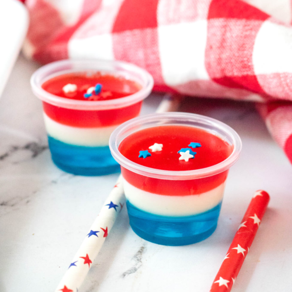Two red, white, and blue Jello shots topped with star sprinkles