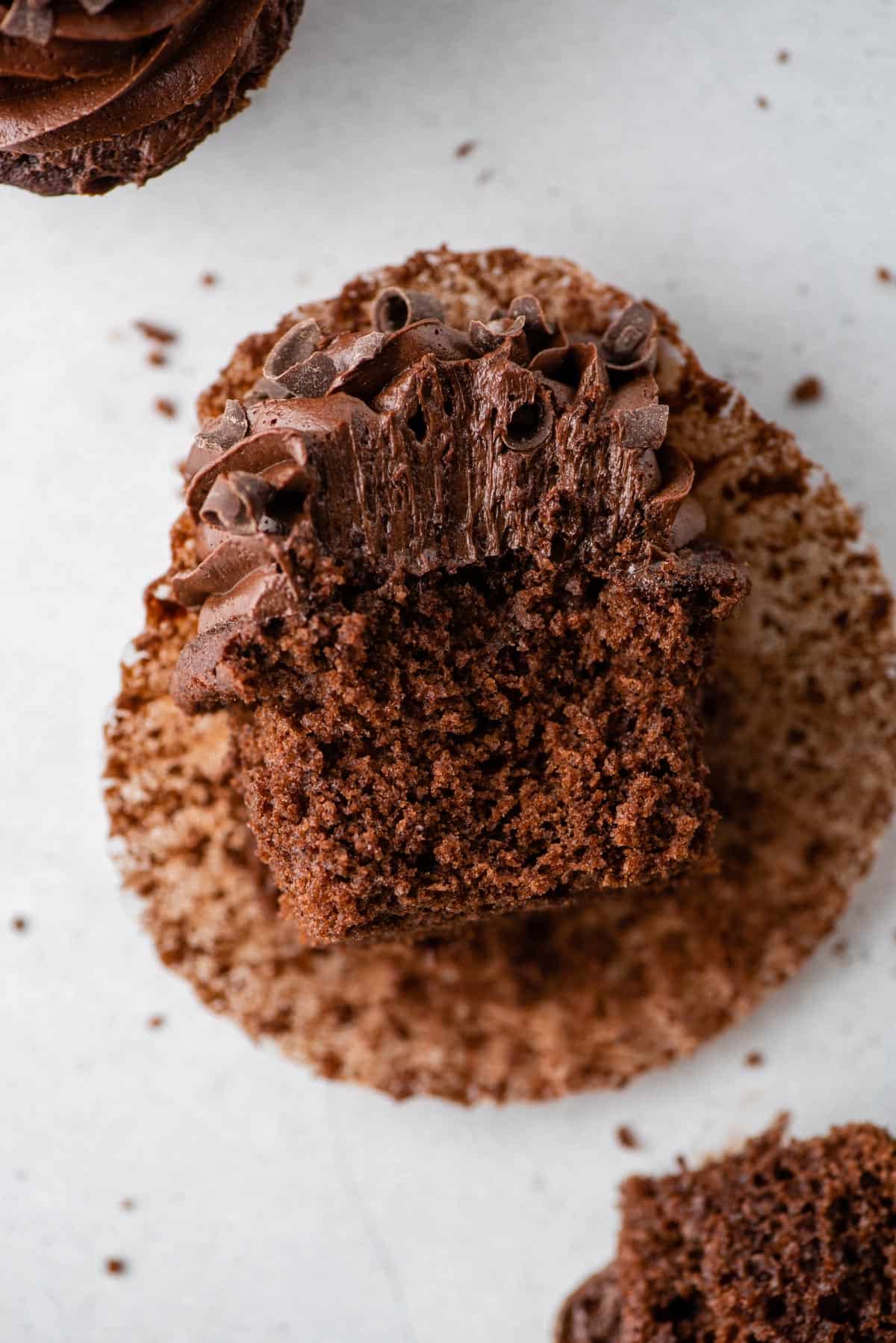 View of a bitten gluten-free chocolate cupcake to show soft, tender cake