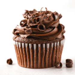 Closeup of a gluten-free chocolate cupcake topped with chocolate curls
