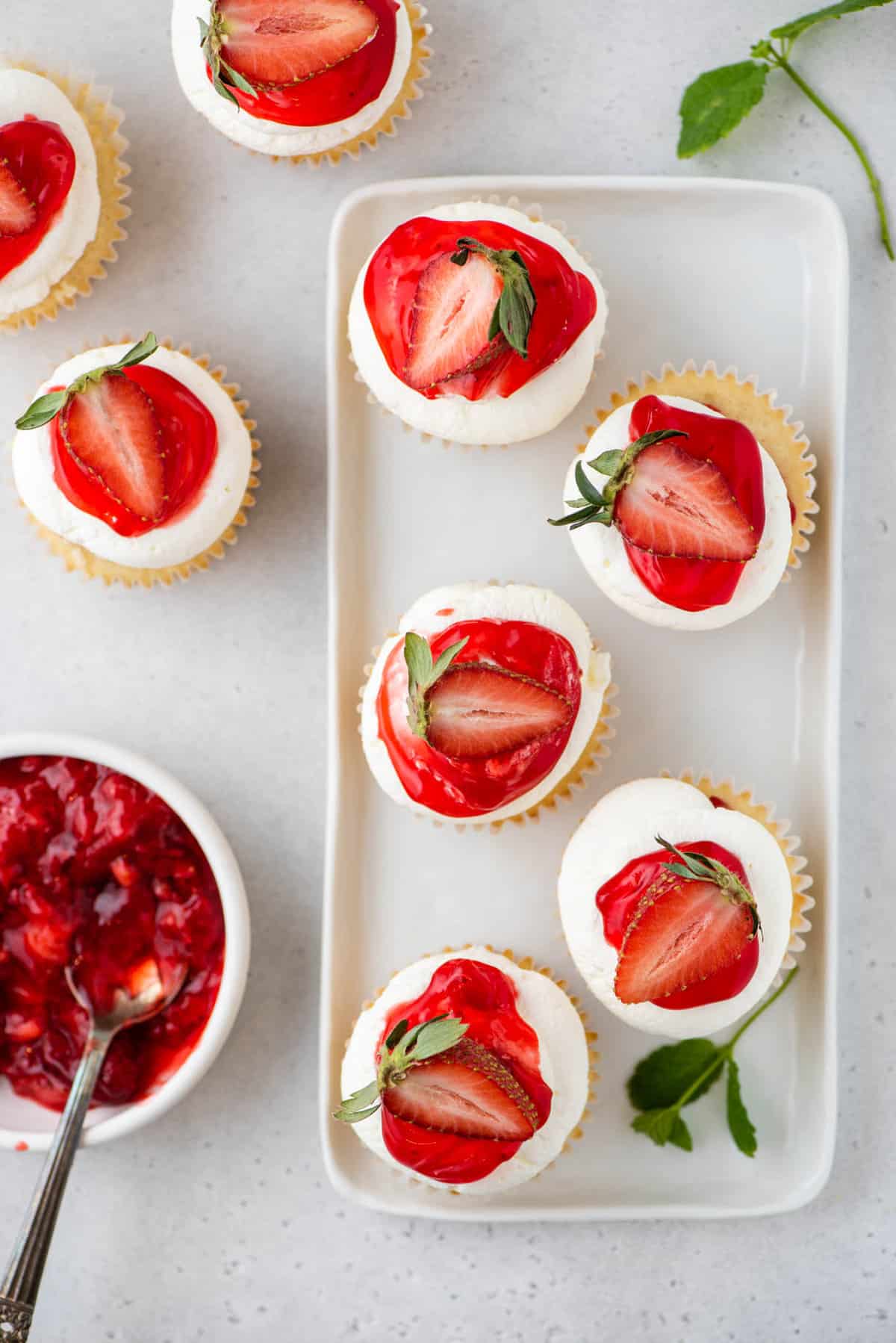Strawberry shortcake cupcakes arranged on small white platter