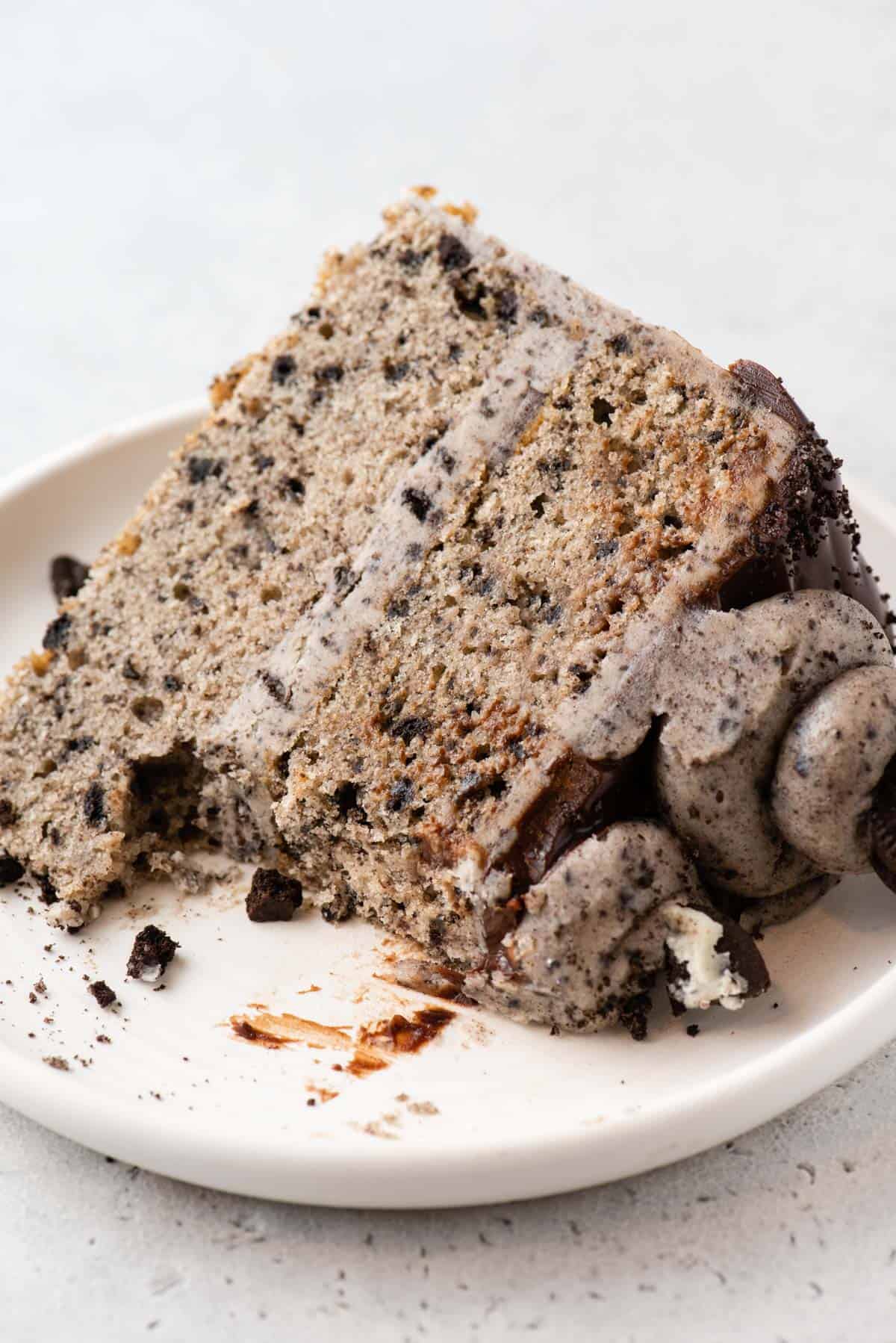 Slice of Oreo cake on plate, with some eaten