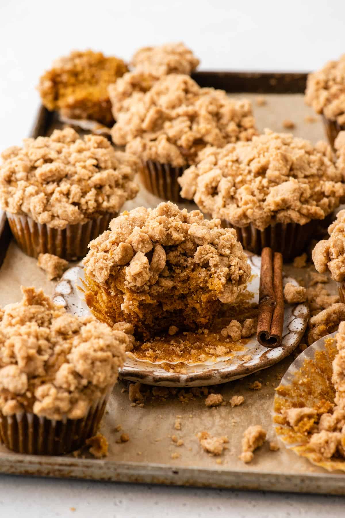 pumpkin muffins topped with streusel arranged on baking sheet