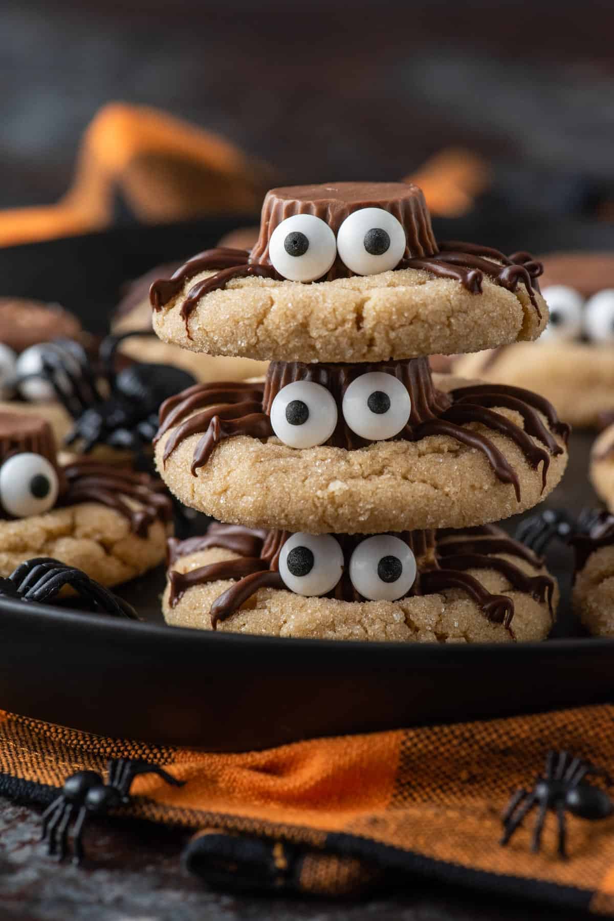 Three peanut butter spider cookies stacked on each other