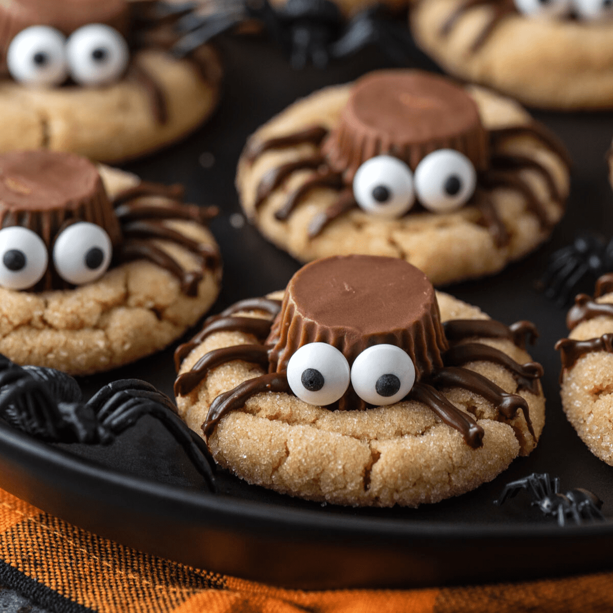 Close up of spider cookies on a black baking sheet
