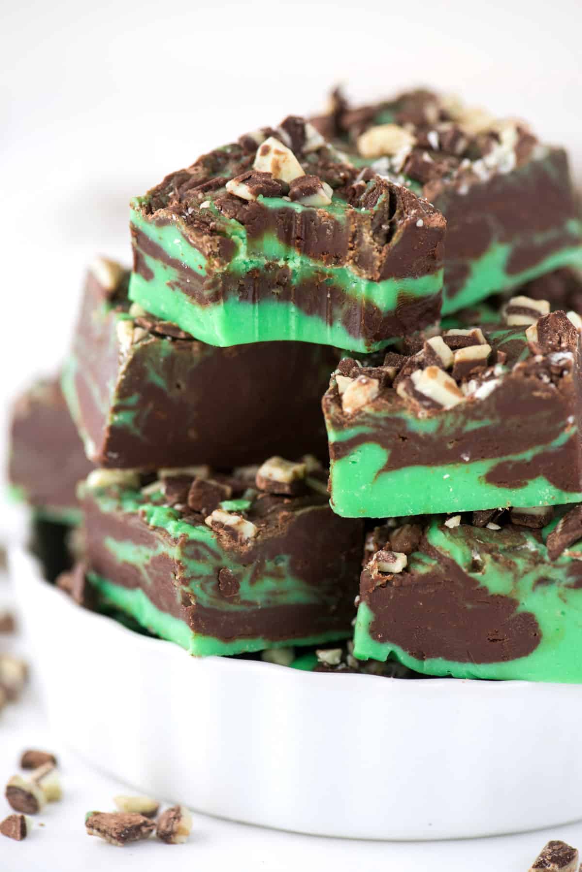 mint chocolate fudge cut into squares displayed in white container
