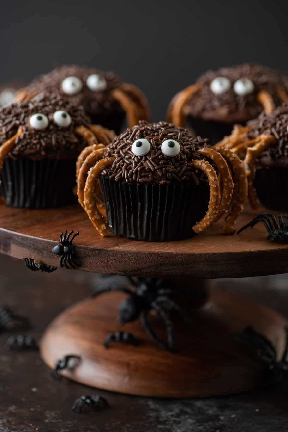 Halloween spider cupcakes on a brown cake plate
