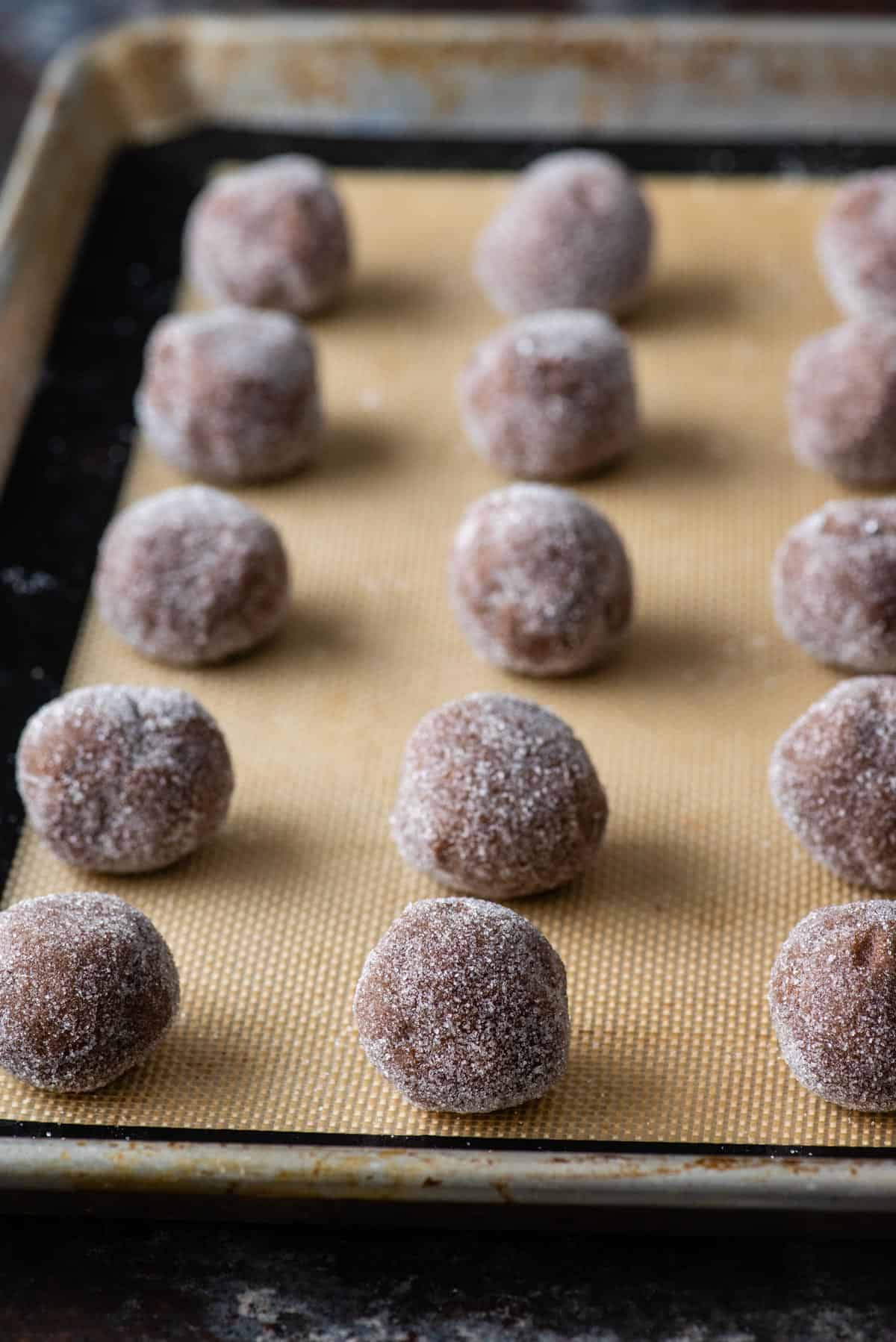 Balls of chocolate cookie dough rolled in sugar