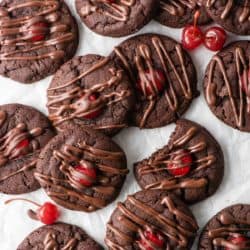 Overhead view of chocolate cherry cookies on a white countertop