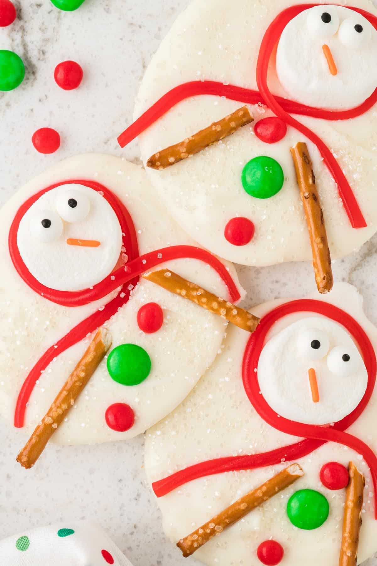 close up of melted snowman bark with marshmallows, twizzlers, pretzels and candies