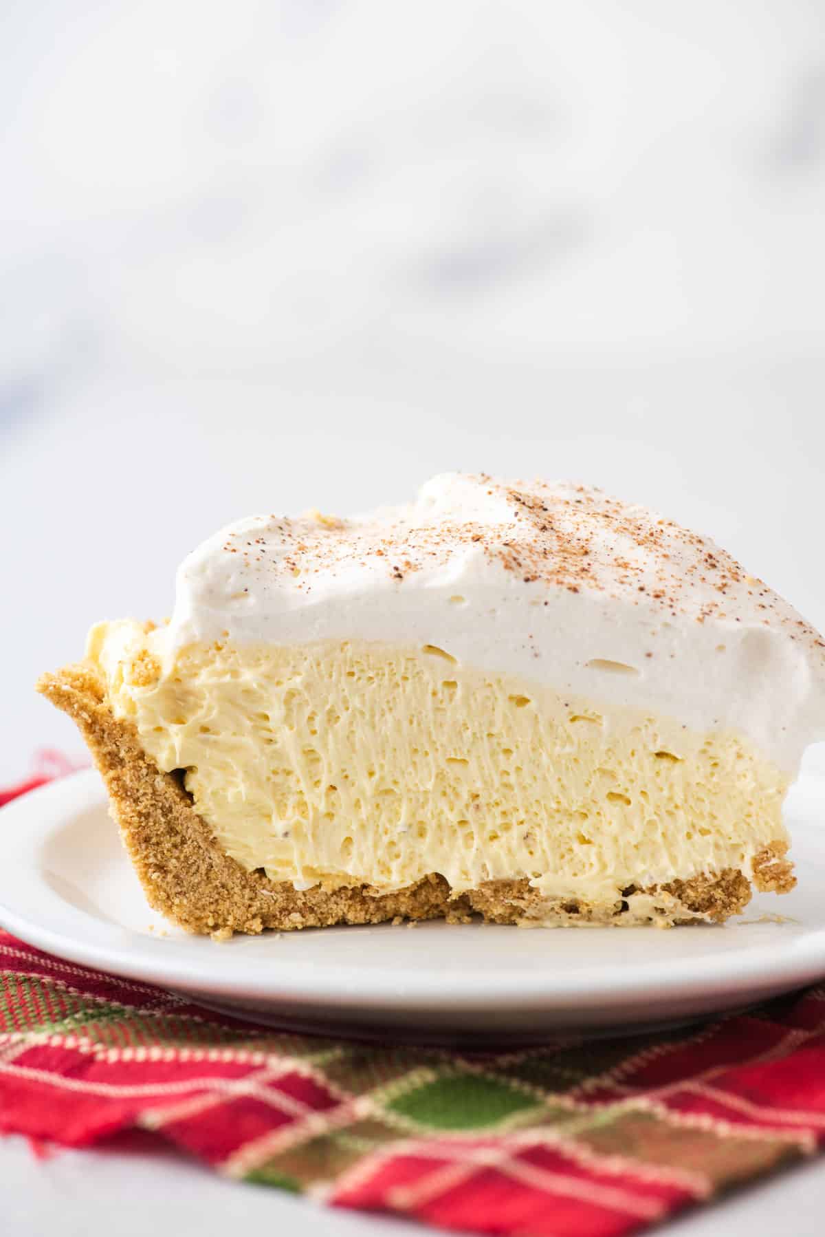 A slice of eggnog pie on a white plate