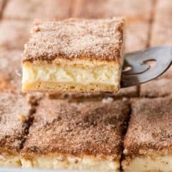 A spatula serving a churro cheesecake bar
