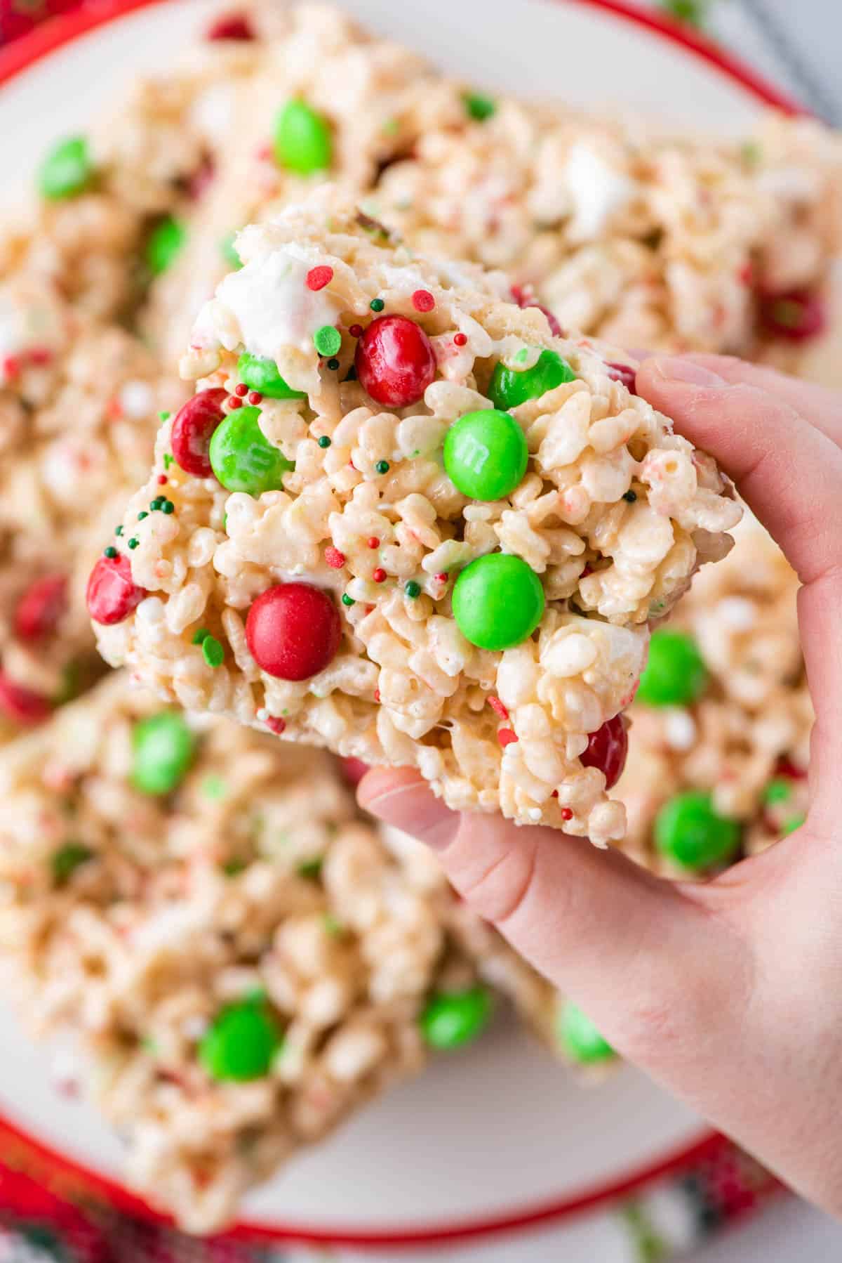 A hand holding a holiday Rice krispie treat