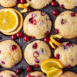 Overhead view of bakery style muffins with orange and cranberries
