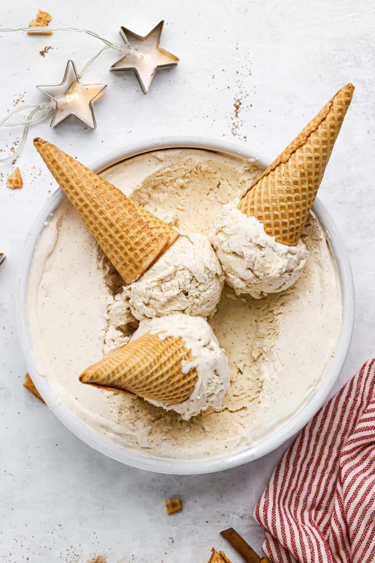 3 waffle cones of eggnog ice cream on the pan of ice cream