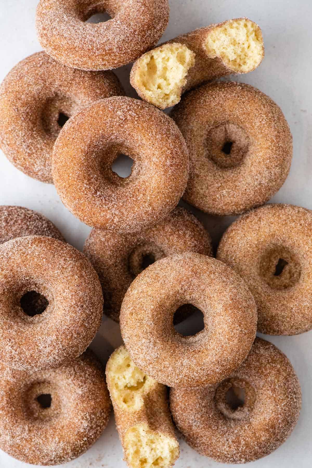 Cinnamon Sugar Donuts arranged in a pile on white background 
