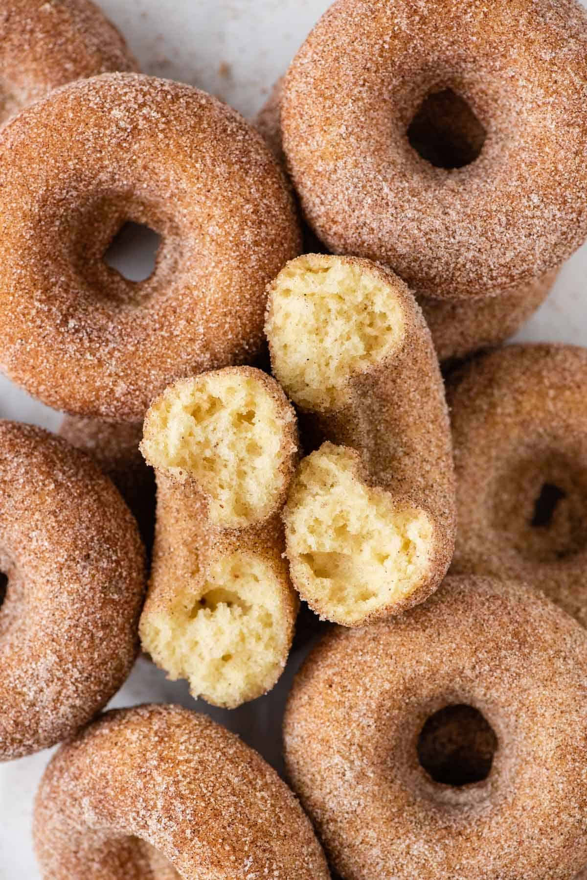 Cinnamon Sugar Donuts arranged in a pile on white background 