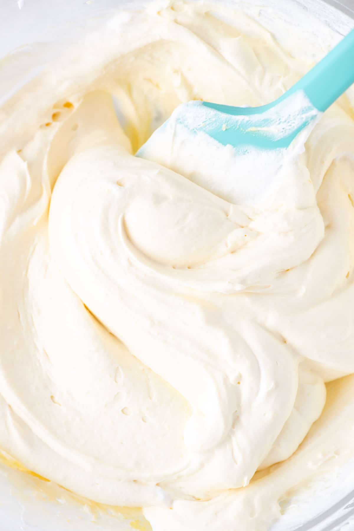 close up of cool whip frosting with a teal spatula
