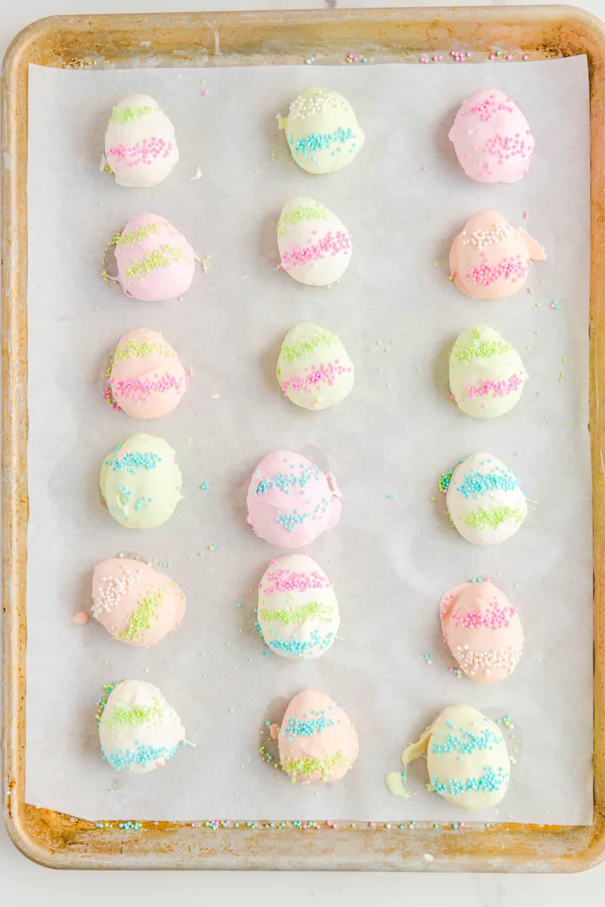 easter egg truffles lined in three columns on a baking sheet