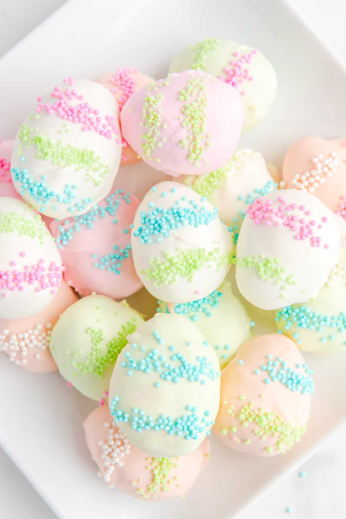 a pile of easter egg truffles on a white plate