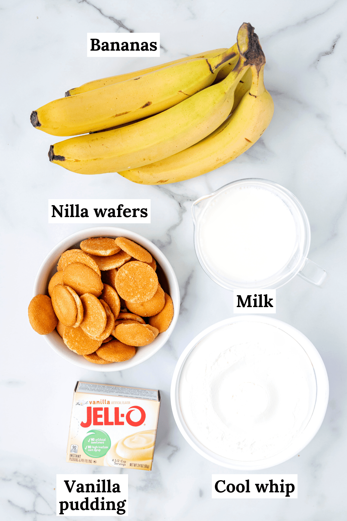 ingredients for easy banana pudding recipe including fresh bananas, milk, nilla wafers, a box of instant vanilla pudding and cool whip