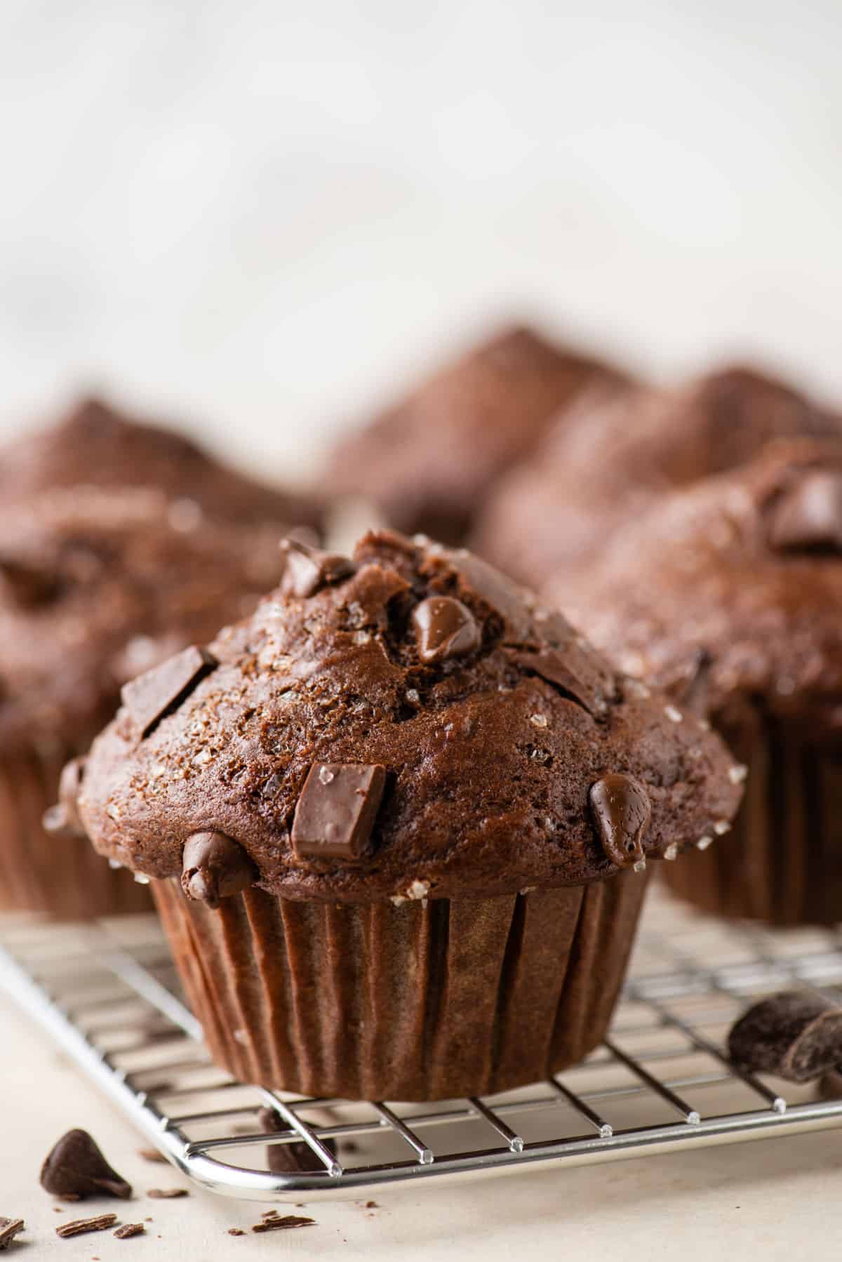chocolate banana muffins on top of a cooling rack