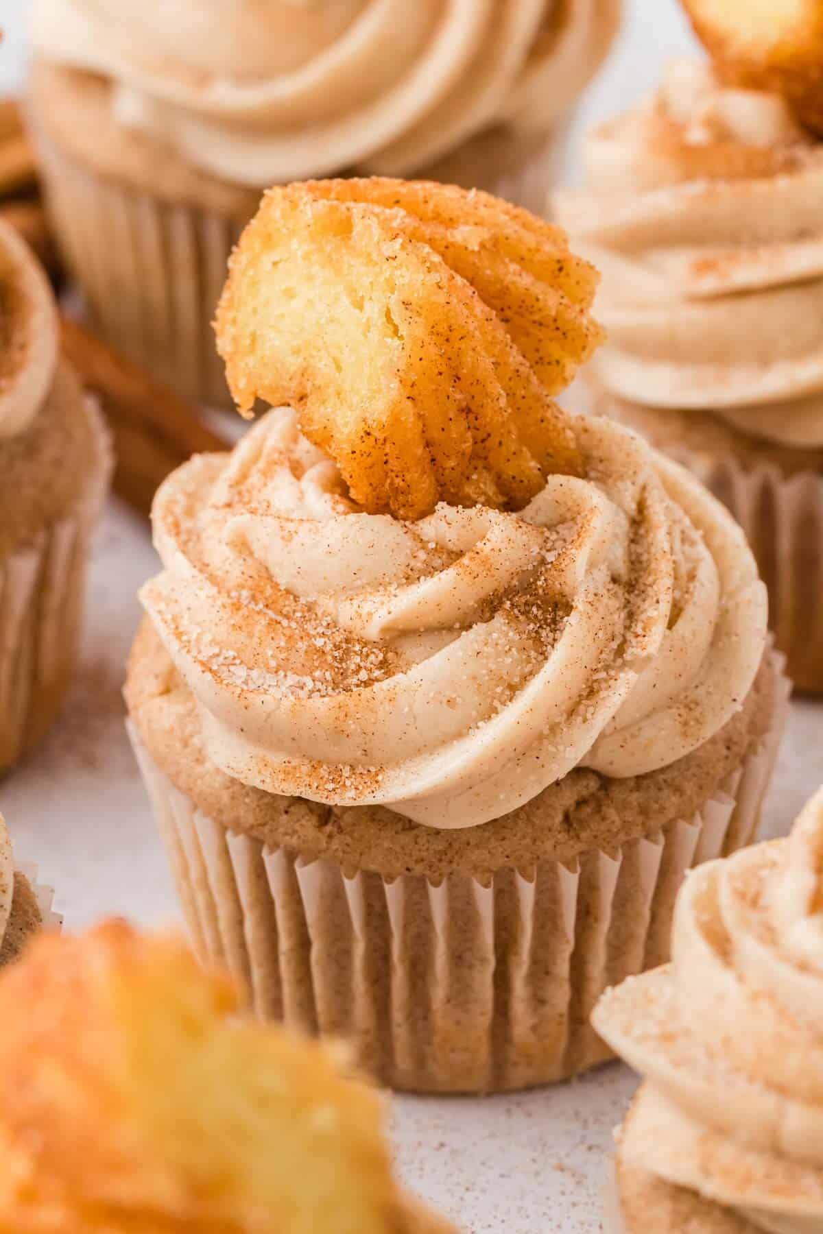 close up of the tops of churro cupcakes topped with churro pieces
