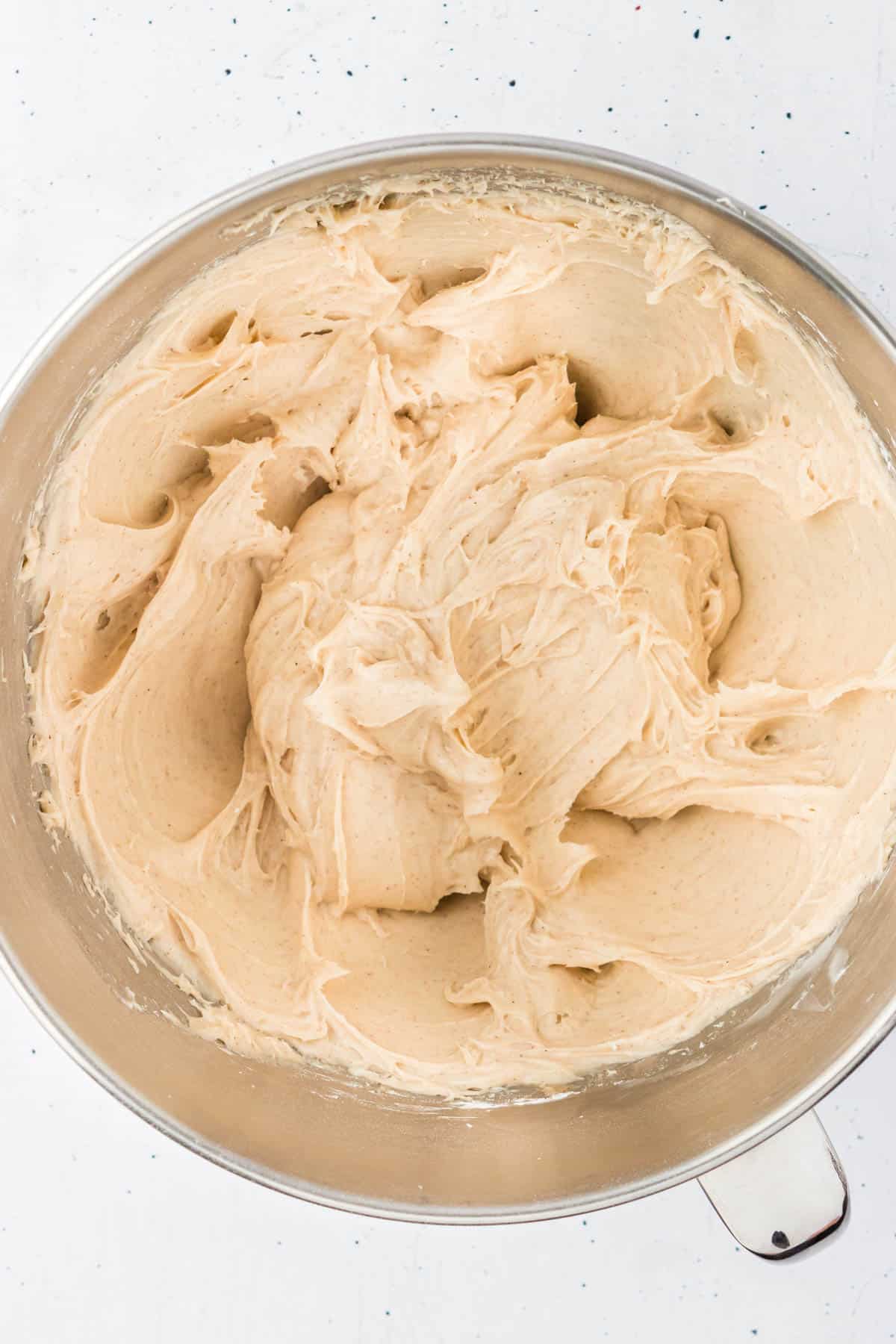 cinnamon cream cheese frosting in a large mixing bowl that has just been combined